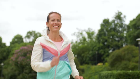 Smiling Woman Running Along Park 