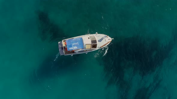 Aerial view of motor boat anchored on the coast of Varko, Greece.