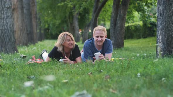 Mature Woman with Adult Son Resting in a Park