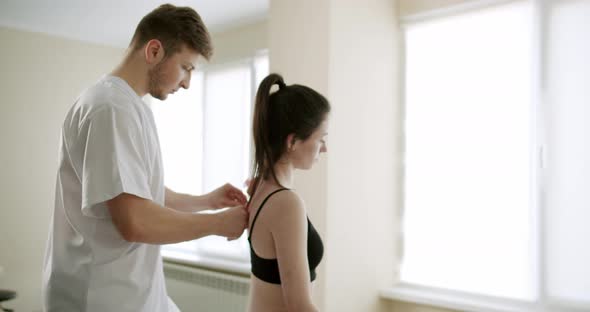 The Doctor is Treating a Woman with Suckers Cups on Her Back in a Clinic