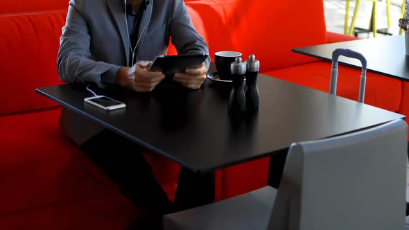 Businessman using digital tablet in hotel