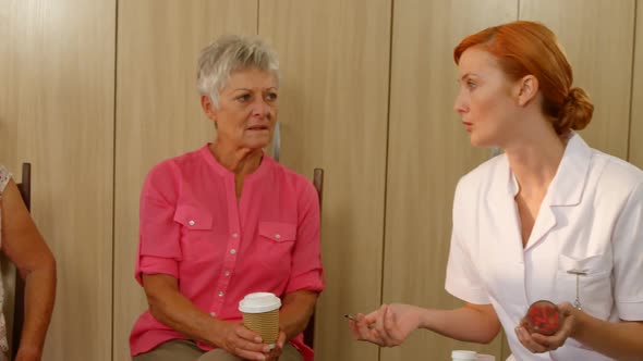 Therapist talking to two senior women