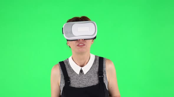 Portrait of Funny Girl with Virtual Reality Headset or 3d Glasses. Green Screen