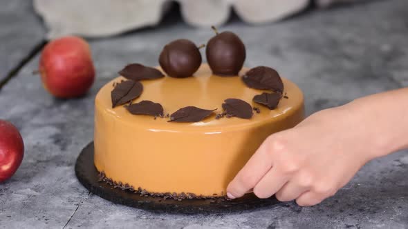 Pastry Chef Decorating the Mousse Cake with Small Chocolate Pieces. Pastry Chef Decorated Modern