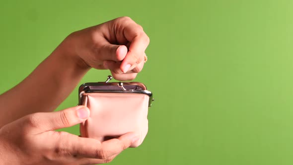  Women Hand Saving Coins in a Purse on Green Screen 