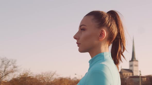 Young, beautiful and sporty woman having evening training outdoor.