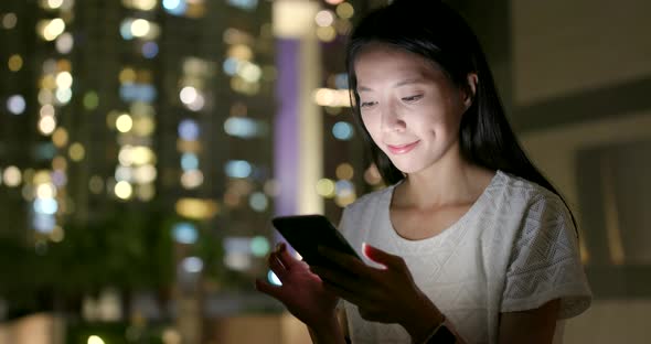 Young woman use of smart phone at night