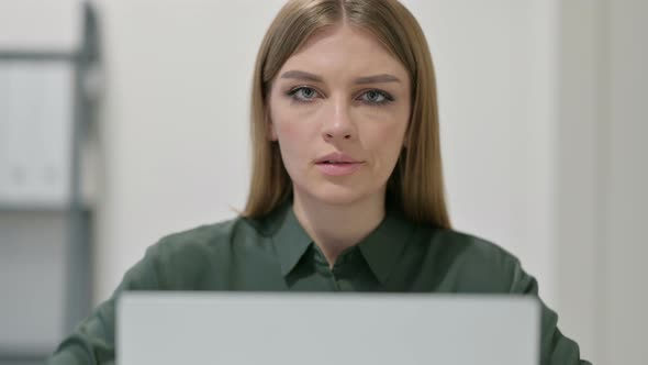 Portrait of Thumbs Down By Woman Using Laptop 