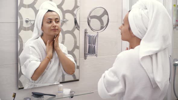 Woman Applying Cream on Her Neck