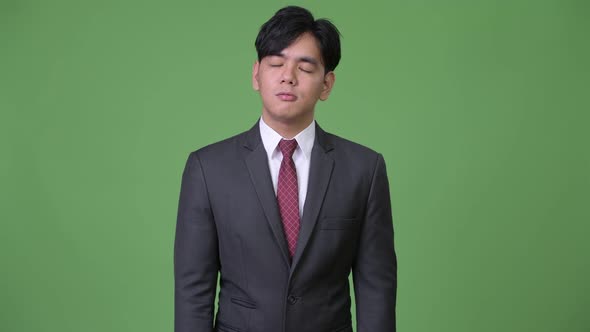 Young Handsome Asian Businessman Looking Bored