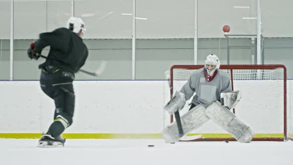 Hockey Players Practicing with Pucks