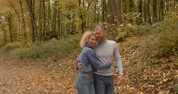 Loving Couple in Jeans on a Date in the Autumn Park