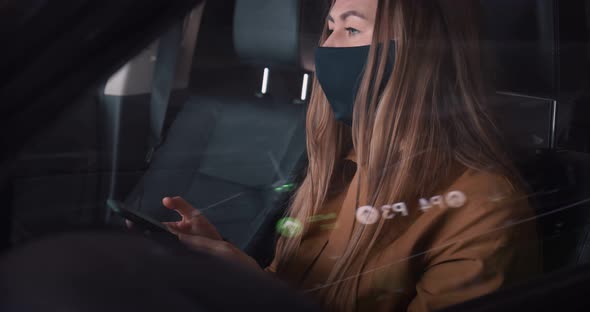 Closeup Young Serious Beautiful Business Woman in Face Mask Using Smartphone to Work in Car Driver