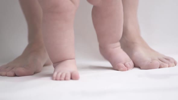 Close-up of a young child's legs learning to walk