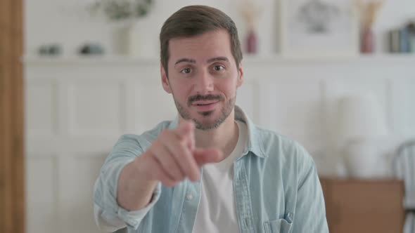 Portrait of Young Man Pointing at the Camera