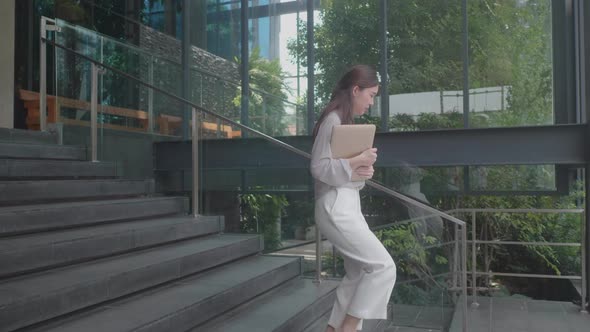 young Asian women walking for work at co-working space modern office