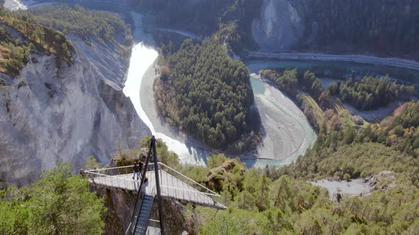 Hikers Looking from an Observation Deck Overlooking Ruinaulta in Switzerland