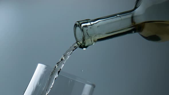 White Wine Flowing Glass Closeup