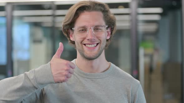 Portrait of Young Businessman Showing Thumbs Up Sign
