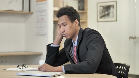 Tired African Businessman Sleeping at Work