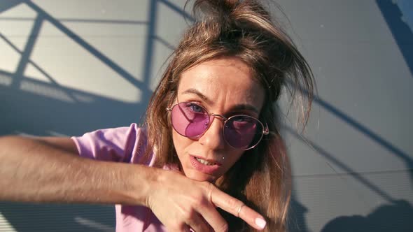 Closeup Dancer Female in Pink Outfit Fooling Dancing at Metallic Wall