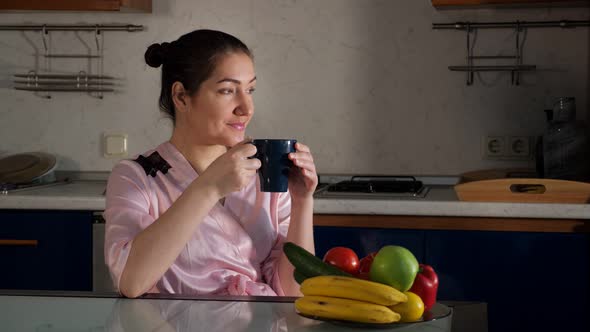 Girl Enjoys Morning Drinking Fragrant Coffee at Darkness