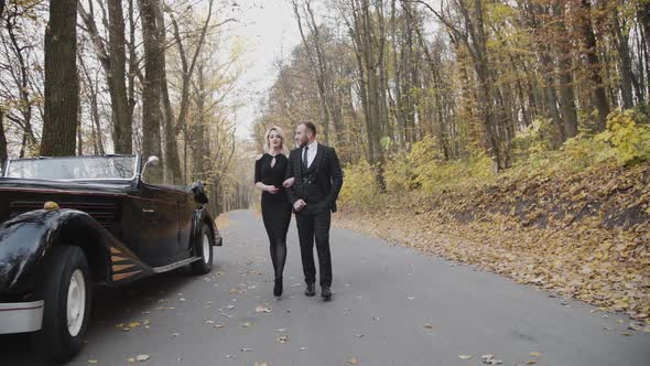 Retro Style of Romantic Couple's Walk Under the Arms in Park