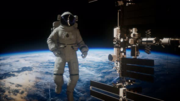 International Space Station and Astronaut in Outer Space Over the Planet Earth alt