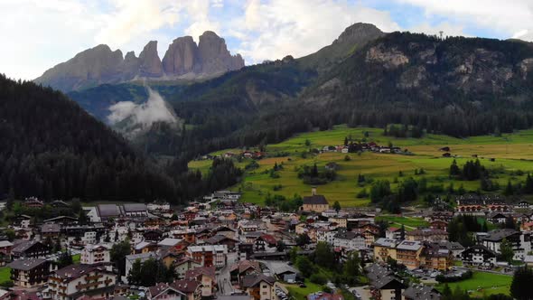 Aerial Scenic view of Cortina d' Ampezzo surrounded by majestic mountains .