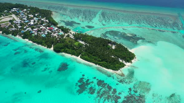 Tropical overhead island view of a white sand paradise beach and turquoise sea background in colourf