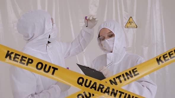 Doctors in the Protective Suits and Masks Looking for a Cure for the Coronavirus