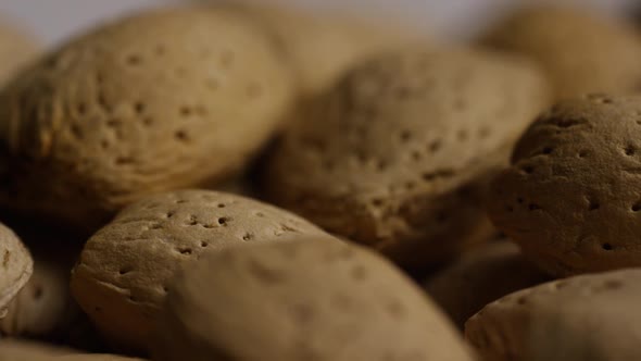 Cinematic, rotating shot of almonds on a white surface 