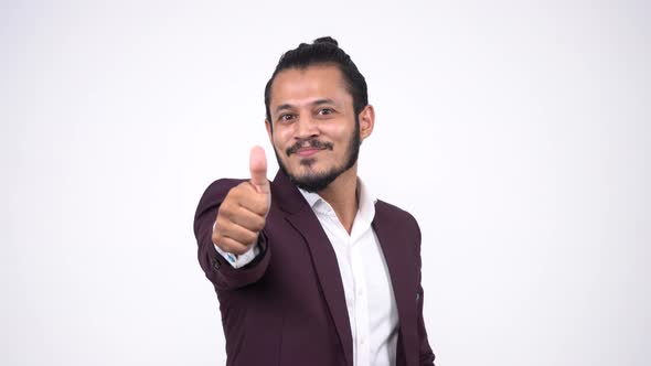 Indian happy smiling young businessman showing thumbs up