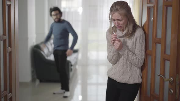 Blurred Caucasian Man Yelling at His Girlfriend or Wife From Background