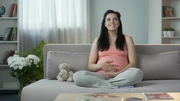 Inspired Pregnant Lady Stroking Tummy, Dreaming of Soonest Appearance of Newborn