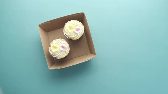 Hand Pick a Cup Cake From a Take Away Box