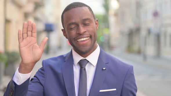 Outdoor African Businessman Waving Welcoming