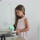 Woman Washing Dishes with Her Daughter - VideoHive Item for Sale