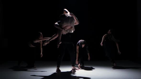 Go on of Contemporary Dance Performance of Five Dancers on Black, Shadow