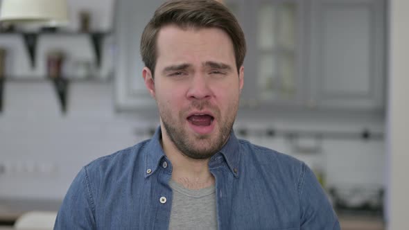 Portrait of Sleepy Beard Young Man Yawning in Office