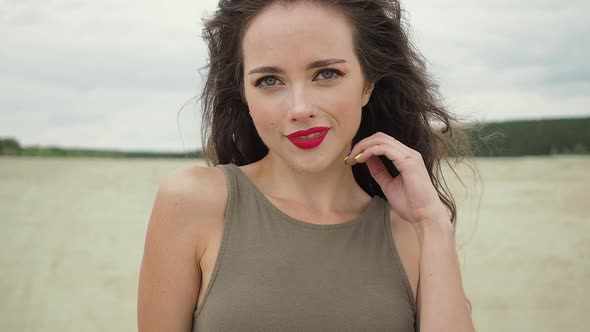 Pretty Woman Touching Hair on Beach