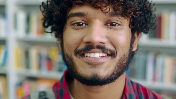 Closeup Video of a Handsome Positive Curly Haired Indian or Arabian Guy in Casual Shirt Manager
