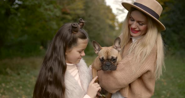 Mother and Daughter with a Dog Outside the City