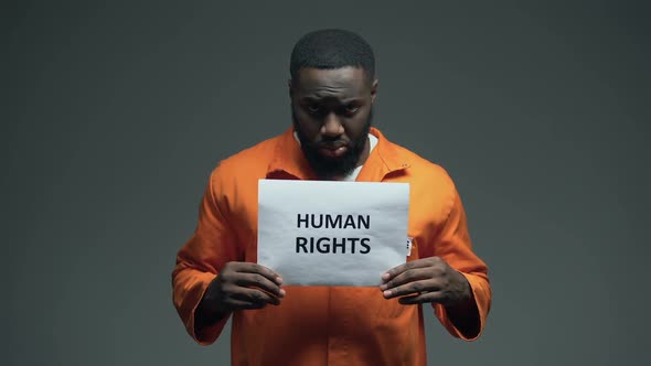 Afro-American Prisoner Holding Human Rights Sign, Ill Treatment, Awareness
