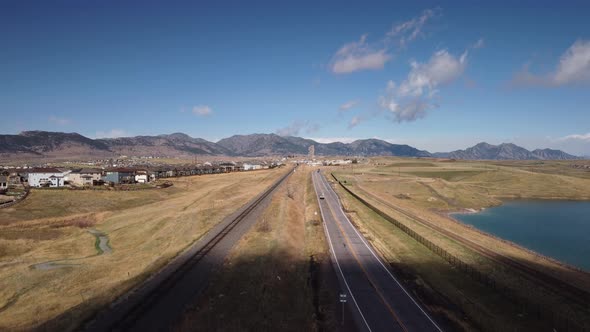 Train tracks and road leading from Rocky Flats to the foothills of the Rocky Mountains in Colorado,