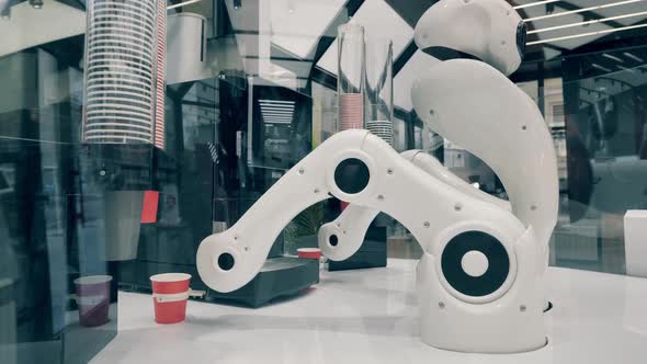 Robot Is Using Arms To Relocate Cups of Coffee