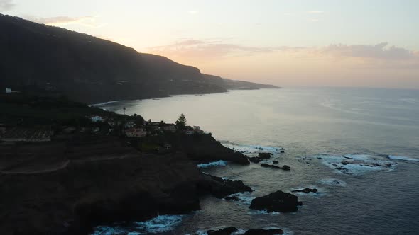 Aerial capture of Punta del Guindastes while flying over it during the sunset, Tenerife