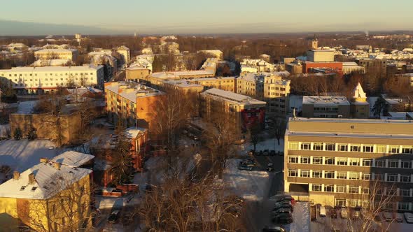 Drone shot over Tähe 4 towards Riia street in winter during sunset