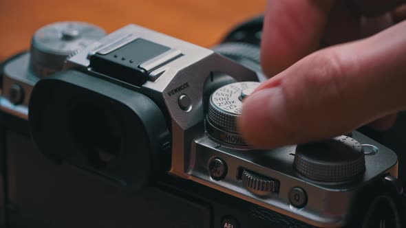 Man's Hands Turn the Aperture Wheel on a Vintage Camera Closeup