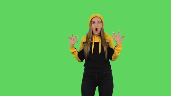 Modern Girl in Yellow Hat with Shocked Surprised Wow Face Expression Is Gesticulating. Green Screen